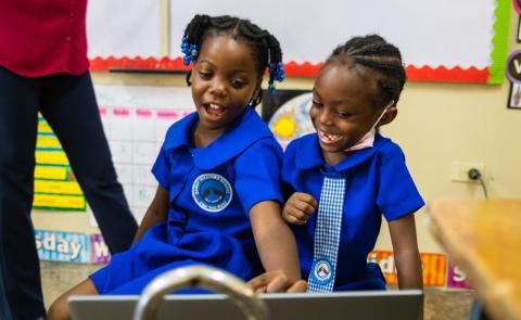 Two young school girls smiling