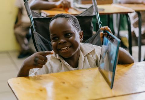 Boy smiling with computer tablet